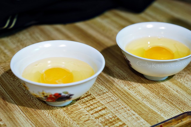 Eggs in cups, waiting to be transferred to simmering water